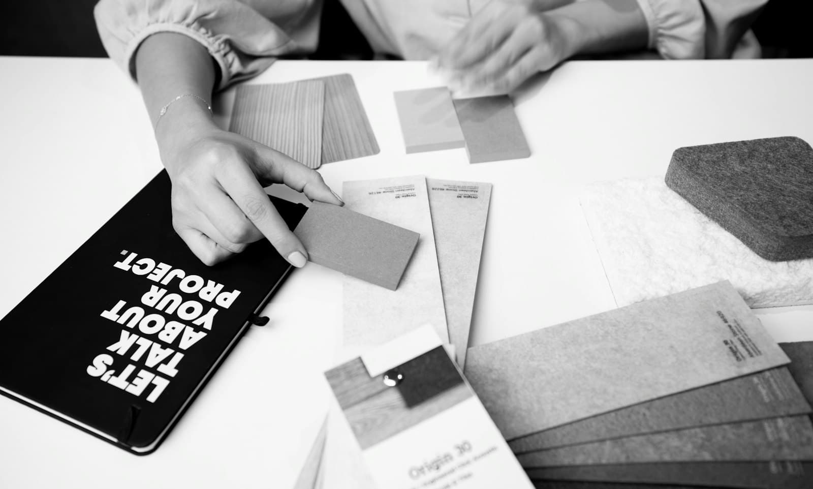 A client and designer reviewing material samples